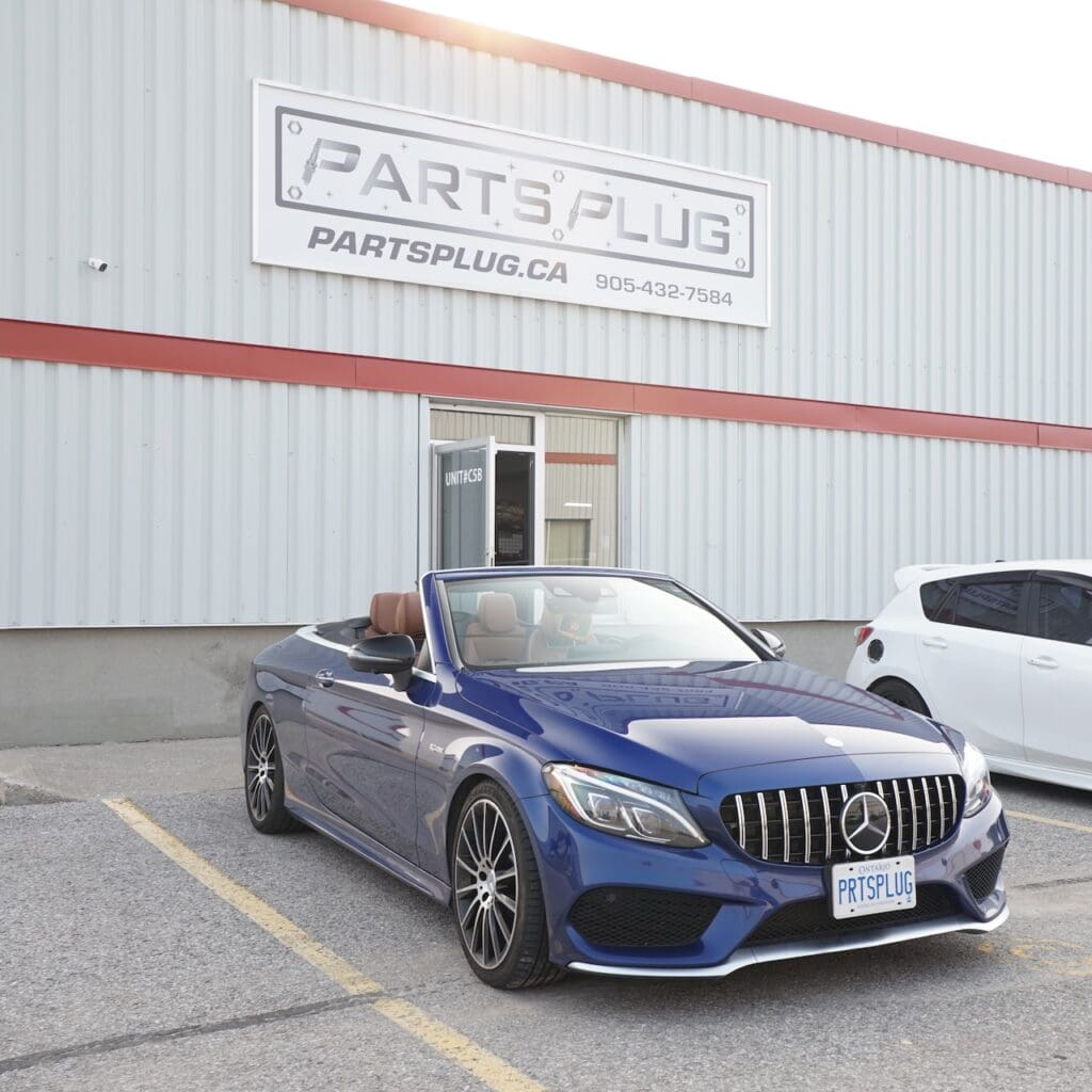 Blue Mercedes-Amg Convertible Parked Outside The Parts Plug Shop